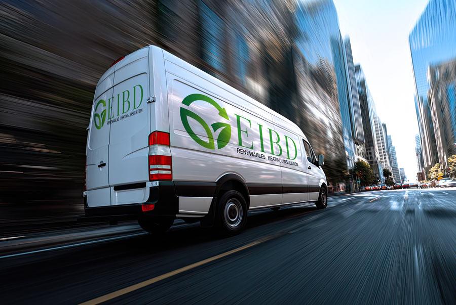 EIBD van driving down a city street lined with tall buildings